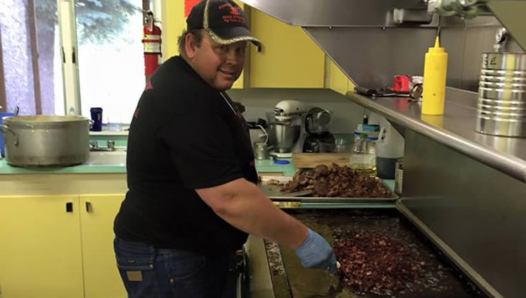 Alumnus Brian Engle cooking the meals for ALC.